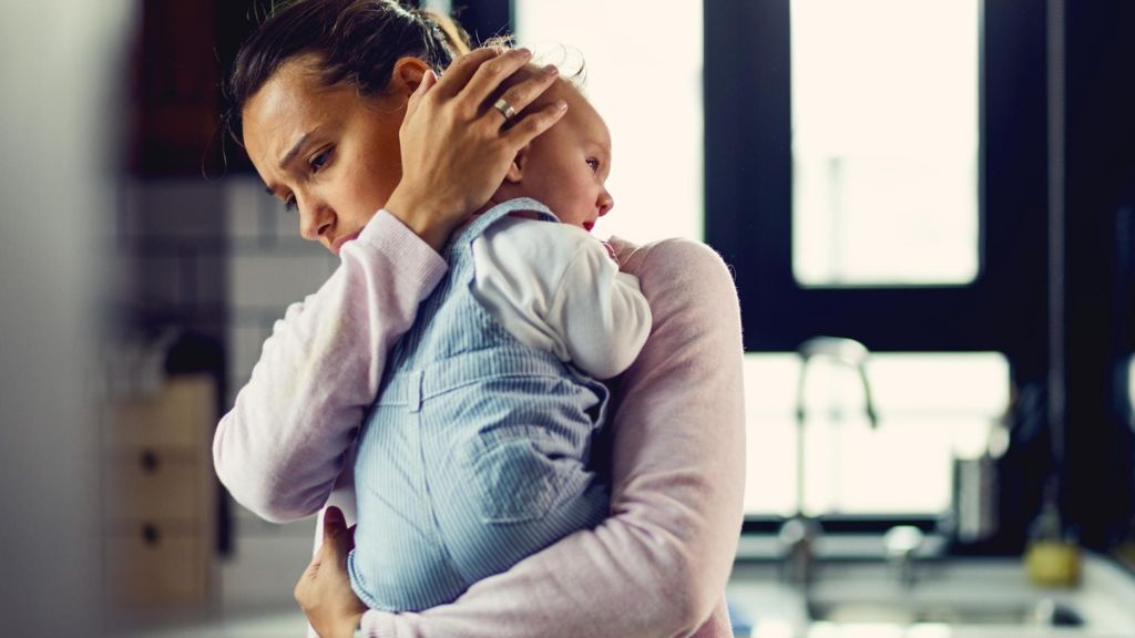 New mother experiencing emotional overwhelm during the postpartum period
